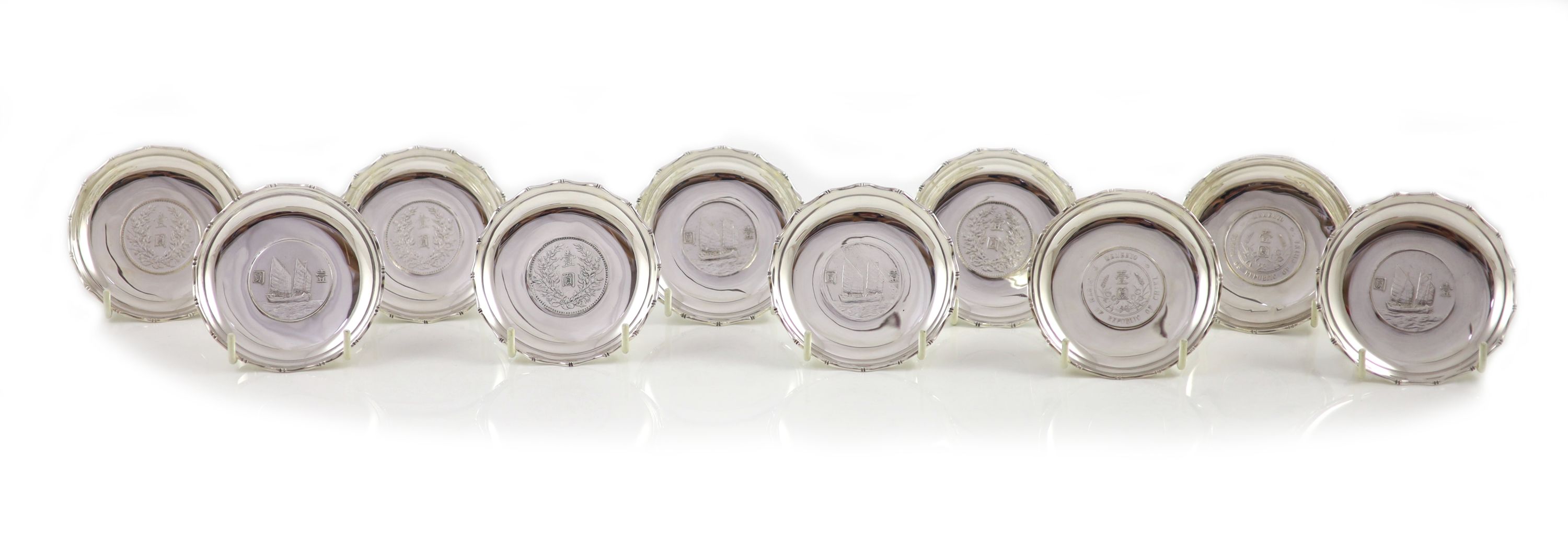 Ten early 20th century Chinese Export small Sterling silver coin inset dishes with shaped 'bamboo' edges, by Tach Hing, Hong Kong,